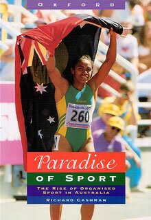 cover photo showing cathy freeman after race with flags